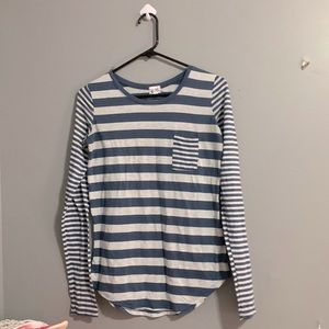 A gray and navy blue striped long sleeve top